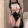 Woman wearing a sexy bunny costume set with a white cropped top, black bow tie, and high-waisted bodysuit.