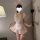 Woman wearing pink lace sheer bunny maid costume with apron, garter, and ears for role play lingerie.