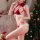 Woman in red lace lingerie set with bunny ears, posing by christmas tree. perfect for festive holiday costumes.