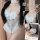 Woman modeling a white sexy cat bunny girl costume, a flirty ruffle bodysuit with sheer lace and cute alluring lingerie detai...