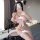 Woman in pink cat-ear lingerie set with fluffy accents, bow details, fishnet stockings, and lace cuffs — playful roleplay cos...