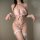 Woman wearing pink fluffy bunny girl lingerie set with garter stockings and choker, hot role play sleepwear ensemble.