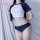 Model wearing a sexy collegiate-style lingerie set featuring a high-waisted bikini top and shorty bottoms, designed to enhanc...