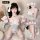 Woman modeling white bunny girl lingerie bodysuit with paw gloves, ears, and garter stockings in a playful cosplay outfit.