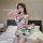 Woman wearing a sexy cow costume lingerie set with playful open-crotch design, featuring cute matching sleepwear and accessor...