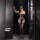 Woman in black lace-up bodysuit with cross-back design, posing in a dimly lit room. perfect for role play and bondage.