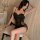 Woman wearing a black deep v lace sleep dress set with sheer mesh cami and skirt, featuring a flirty wrinkled bodice.