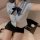 Sexy female police officer costume with tight shirt, bow tie, and mini skirt for role play, cosplay, or themed events.