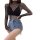 Woman wearing a black fishnet bodysuit with long sleeves and matching stockings, paired with denim shorts.