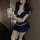 Woman in navy blue sailor-style flight attendant costume with short skirt and cropped top, posing seductively for mirror self...