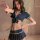 Woman modeling a sexy flight attendant costume with a navy blue skirt and busty top, perfect for role play or plus size linge...