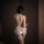 Woman wearing sexy halter lace open-crotch bare-butt bodysuit set, showcasing romantic and pure temptation lingerie design.