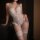 Woman wearing a sexy halter lace open-crotch bare-butt bodysuit set with matching thigh-high stockings, exuding romantic allu...