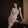 Woman modeling white lace halter bodysuit with open-crotch design and matching thigh-high stockings, romantic sensual lingeri...