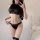 Woman modeling black sheer mesh bodysuit with hip-hugging design and jason textile branding on waistband.