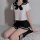 Sexy innocent schoolgirl lingerie set featuring a pleated mini skirt, sailor-style top with bow, and knee-high socks, perfect...