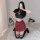 Woman modeling sexy jk style lingerie set with red plaid skirt, black crop top, and striped socks on white rug.