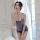 Woman posing in a sheer, gray lace babydoll nightgown set with push-up effect, perfect for flirty boudoir moments.