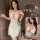 Woman wearing white cherry-print babydoll sleep set with red straps and built-in pads — sexy lace lingerie for role play nigh...