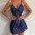 Woman wearing a sexy blue lace bodycon mini dress with sheer panels and floral detailing, elegant thermal lingerie style.