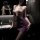 Woman in bathroom wearing sexy lace bodycon mini dress with sheer cutouts and matching sleepwear lingerie set.