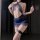 Woman wearing blue lace bodycon mini dress with fishnet stockings, showcasing seductive lingerie set for roleplay and sleepwe...
