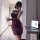 Woman in sexy lace bodycon mini dress with built-in pads, holding wine glass, taking mirror selfie.