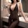 Woman modeling a sexy lace bodysuit with halter neck and sheer mesh, featuring an open-crotch design for plus-size women.