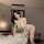 Woman in sexy lace halter bodysuit lingerie set, posing on bed with roses – flirty plus size sleepwear and yoga pants ensembl...