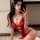 Woman in red lace bodysuit taking selfie, showcasing seductive lingerie with intricate detailing and elegant design.