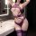 Woman wearing purple lace bodysuit with mesh details and matching thigh-high stockings in a modern bathroom setting.