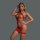 Woman modeling a red sheer mesh bodysuit with rhinestone accents and cut-out details.