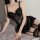 Woman wearing black lace bodysuit set with sheer mesh chemise and matching thong, provocative lingerie for date night.