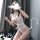Woman posing in white lace bodysuit with sheer mesh and modest cutout design, styled as a provocative nightclub outfit set.