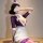 Woman modeling purple lace bodysuit with deep v-neck, white skirt and hat. sexy secretary style sleepwear set for women.