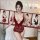 Woman modeling a red lace bodysuit with sheer cut-outs and open-crotch design, styled as seductive sleepwear with uniform-ins...