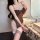 Woman wearing a sexy lace bodysuit with adjustable straps, featuring an open-crotch design and tight fit, posing elegantly be...
