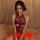 Woman wearing a red lace bodysuit with cheongsam-inspired design, featuring an open-crotch and intricate detailing.