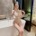 Woman in sexy lace bodysuit with open-crotch cheongsam design, perfect for busty and petite figures, posing in a modern bathr...