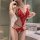 Woman wearing red lace bodysuit with sheer cutouts and open-crotch design in elegant bathroom setting.