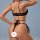 Woman wearing black lace bodysuit with sheer mesh and adjustable straps, back view of erotic lingerie.