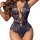 Woman wearing navy blue lace bodysuit with deep v neckline and floral pattern, ultra-thin mini design.