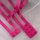 Hot pink adjustable bra straps with metal clasps, part of a sexy lace bra set for women, displayed on soft white fabric.