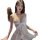 Woman wearing white lace chemise sleepwear set with sheer mesh, high slit, and matching lingerie outfit.