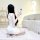 A woman in a white sheer mesh sexy lace cheongsam lingerie set poses seductively while taking a photo, showcasing the elegant...