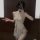Woman modeling sheer lace cheongsam sleepwear with adjustable ties and no-remove design for intimate wear.