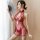 Woman in red lace cheongsam sleepwear with sheer mesh, backless cutout, and embroidered open-crotch design, holding a fan.