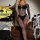 Woman modeling black lace hollow-out bodycon mini skirt set with backless banded bra, perfect for halloween lingerie outfit.