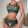 Woman wearing emerald green lace lingerie set with sheer panels, crisscross straps, and cut-out details.