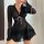 Woman wearing black mesh lingerie set with v-neck, bell sleeves, pink ribbon ties, and ruffled hem.